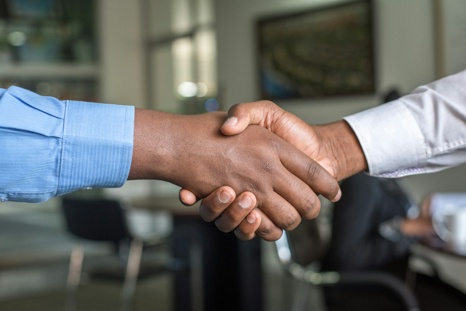 Din Solicitors shaking hands with a satisfied client