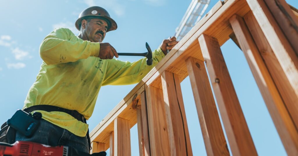 A construction worker in a hard hat on a building site, illustrating a construction accident claim
