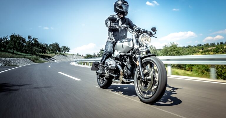 A motorcyclist in full protective gear riding on an open road, illustrating a motorbike accident claim